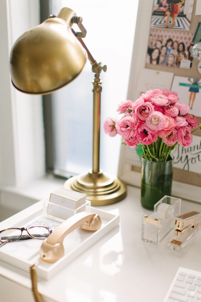 chic workspace ideas with flowers on a desk.