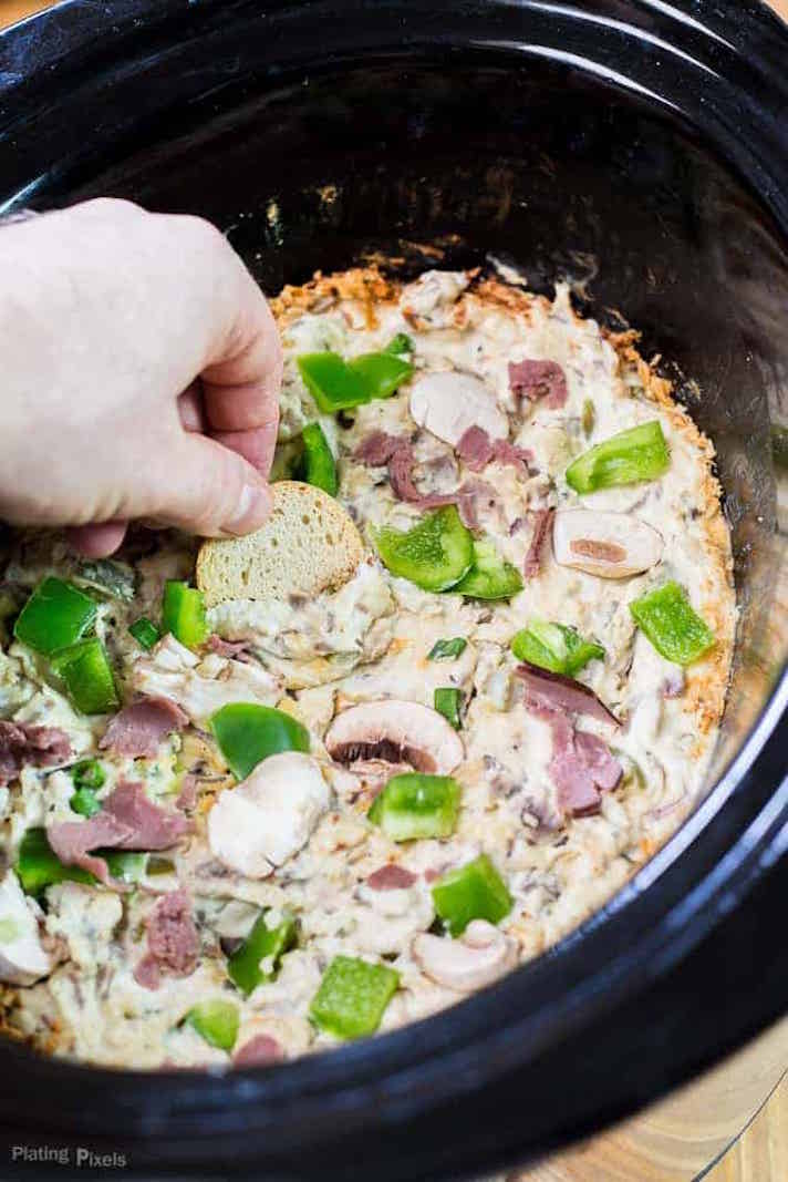 STYLECASTER | 17 Superbowl Snacks You Can Make In a Slow-Cooker | Philly Cheesesteak Dip