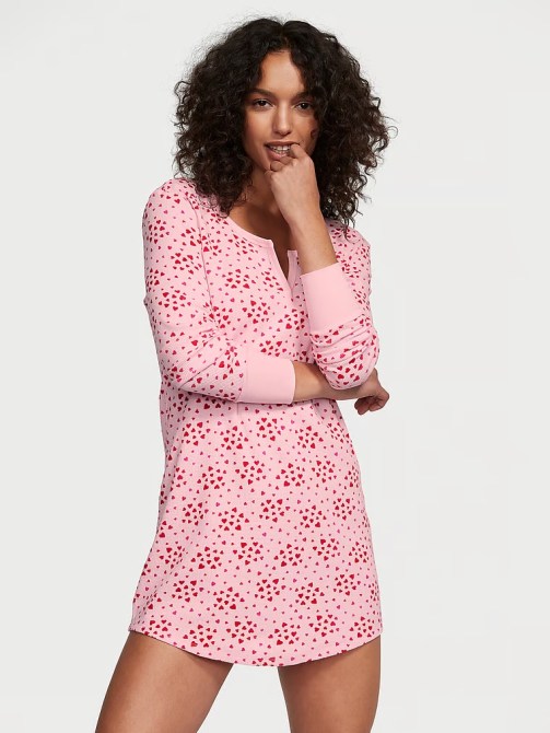 A model wearing a pink heart-print sleepshirt from Victoria's Secret