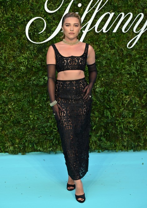 Florence Pugh in a black lace two-piece and sheer black gloves at a Tiffany exhibition gala