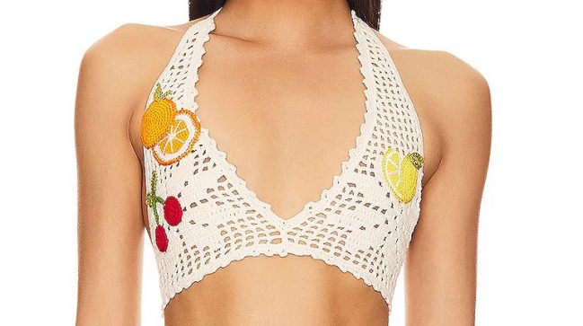 Model wears cream crochet bikini with fruit appliques.