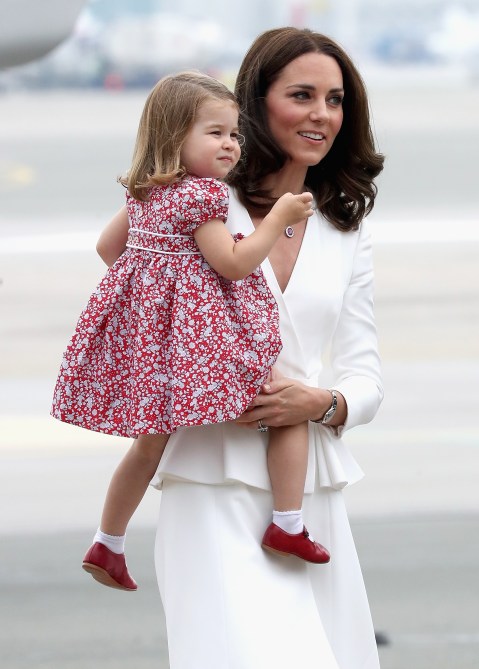 Catherine, Duchess of Cambridge carries Princess Charlotte of Cambridge as they arrive with Prince William, Duke of Cambridge and Prince George of Cambridge on day 1 of their official visit to Poland on July 17, 2017 in Warsaw, Poland.