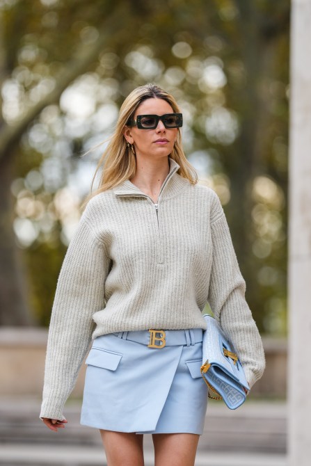 A Paris fashion week guest wearing rectangular sunglasses.