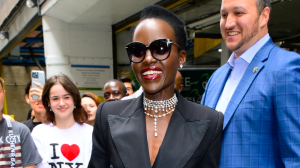 Lupita Nyong’o wearing sunglasses and a black blazer.
