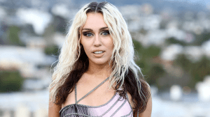 Miley Cyrus with bleach blonde and dark brown hair.