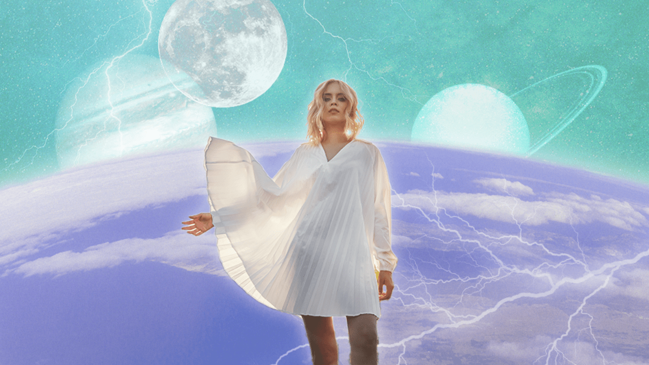 A woman standing in front of the cosmos with wind blowing her skirt