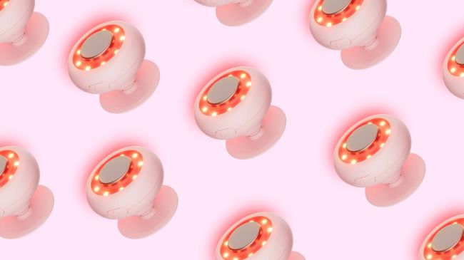 Solawave Mini Red Light Therapy Device on a Pink Background 