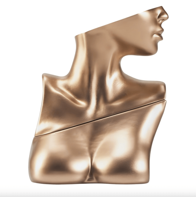 Billie Eilish Eau de Parfum in a gold bottle shaped like the bust of a woman.