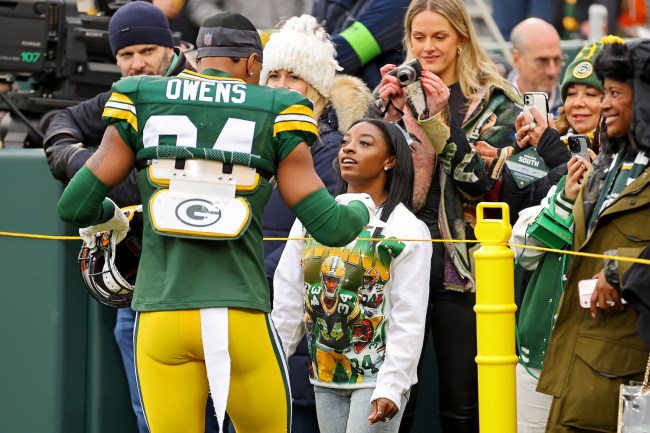 Simone Biles talks with her husband Jonathan Owens #34 of the Green Bay Packers prior to a game against the Minnesota Vikings at Lambeau Field on October 29, 2023 in Green Bay, Wisconsin. 