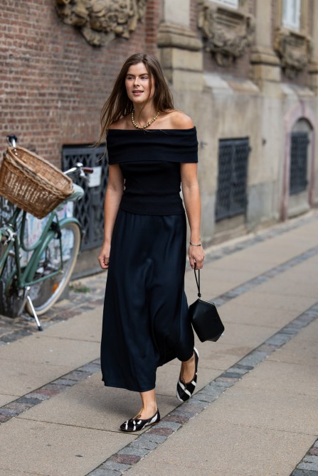 STYLECASTER | Minimalist Outift Ideas, off the shoulder black top, black skirt, zebra stripe ballet flats.