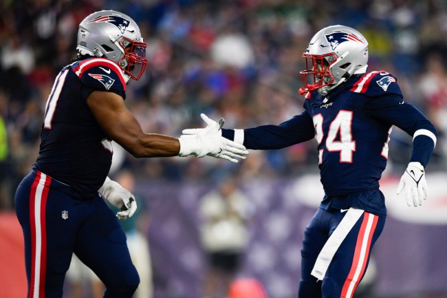 Deatrich Wise Jr. #91 and Joshuah Bledsoe #24 of the New England Patriots slap hands  during the first half of a preseason game against the Philadelphia Eagles at Gillette Stadium on August 15, 2024 in Foxborough, Massachusetts.