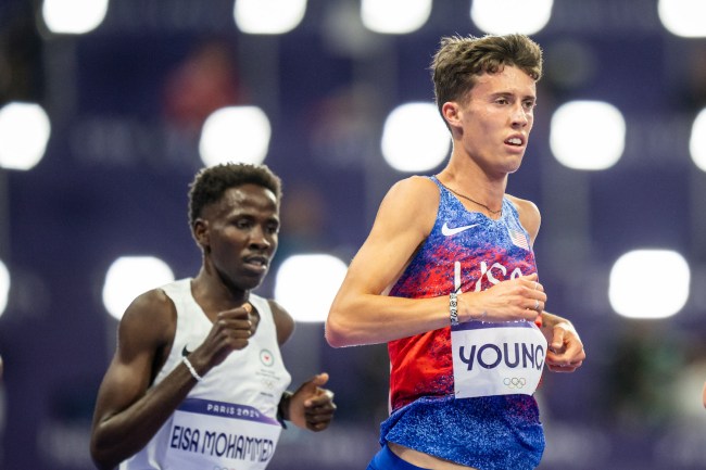 Jamal Abdelmaji Eisa Mohammed of Refugee Team and Nico Young of Team United States competes during the Men's 10.000 Metres final on day seven of the Olympic Games Paris 2024 at Stade de France on August 2, 2024 in Paris, France.