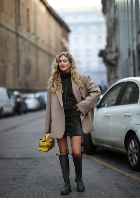 Emili Sindlev wearing a Loewe bag and Ganni boots outside Max Mara during Milan Fashion Week Fall/Winter 2020-2021 on February 19, 2020 in Milan, Italy.