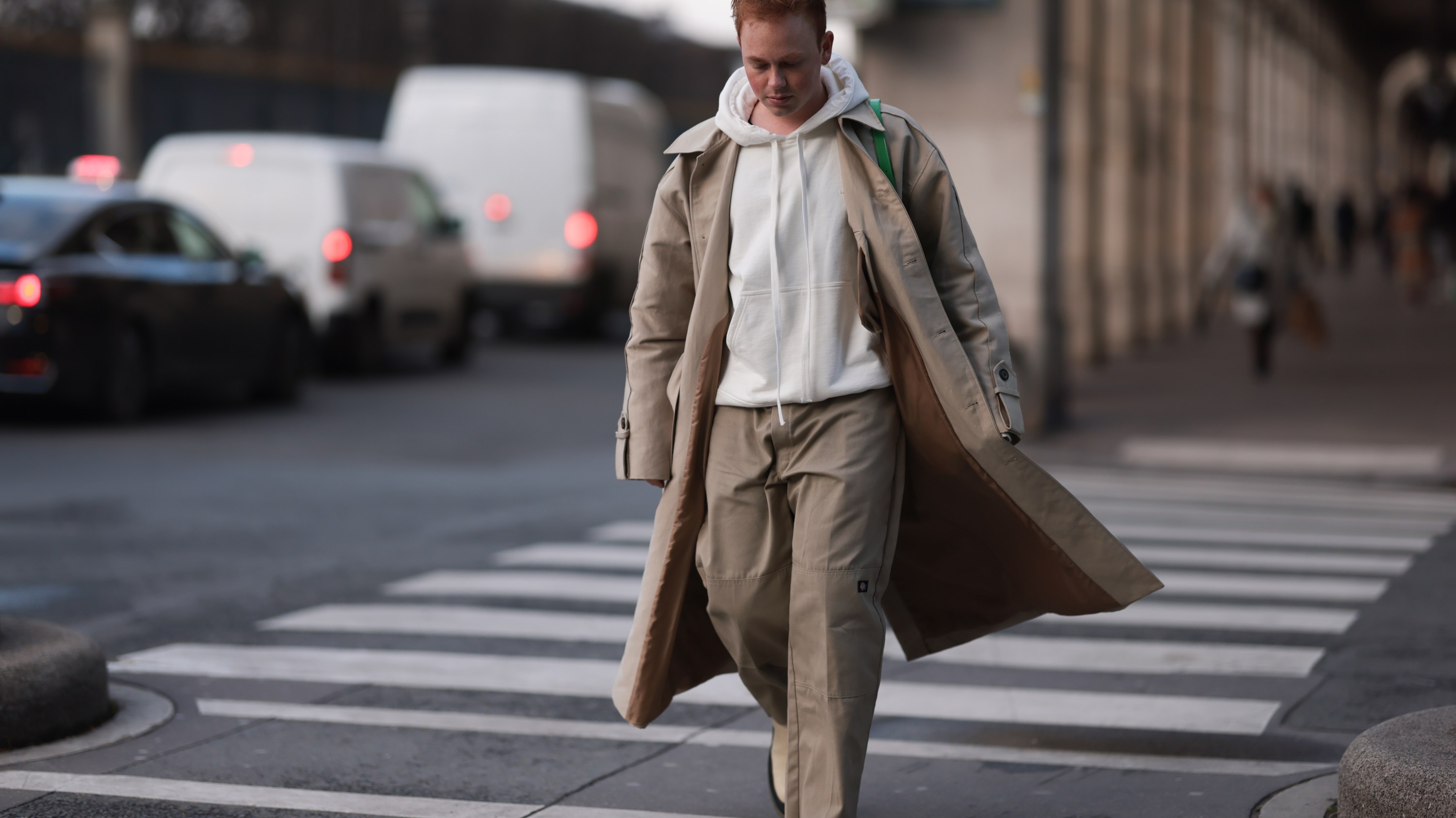 Erik Scholz seen wearing a ByFar green leather bag, a vintage beige trenchcoat, Dickies beige wide leg pants, Bottega Veneta beige leather boots and a 032C beige sweater on January 20, 2023 in Paris, France.