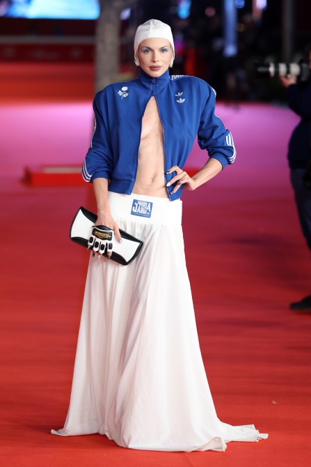 Julia Fox wearing a blue Willy Chavarria Adidas track jacket on the red carpet.