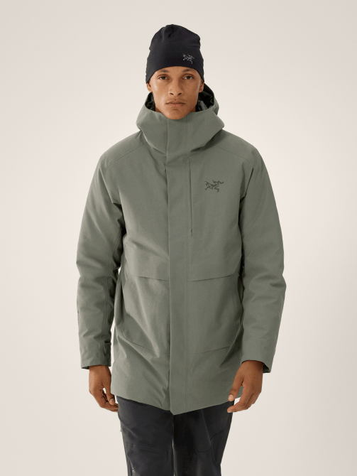 A model wearing the Arc’teryx Therme Down Parka Men's in a green-grey colorway