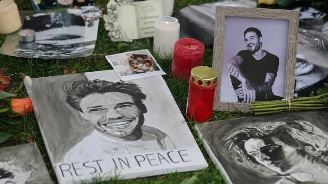MUNICH, GERMANY - OCTOBER 20: Memorabilia are left by fans as they gather around a tree adorned with flowers, handwritten messages and photos near the Olympiahalle during a tribute event for One Direction singer Liam Payne on October 20, 2024 in Munich, Germany. The former One Direction singer fell to his death from a hotel balcony in Buenos Aires on Oct. 16th.