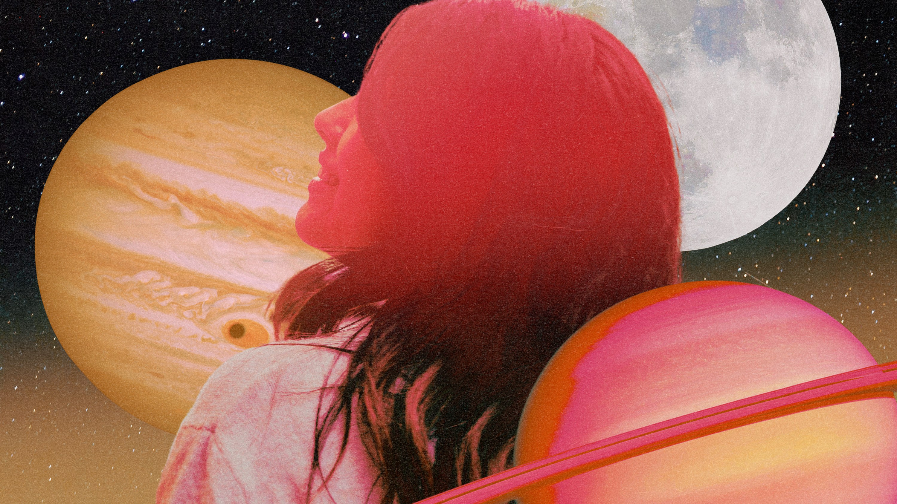 A woman flushed in pink hues smiling in front of a series of planets in the sky