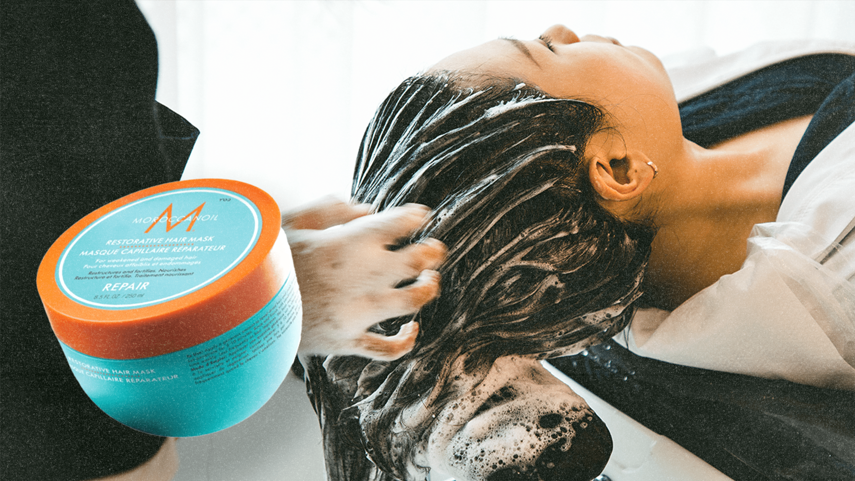 A woman putting on a hair mask next to the Moroccanoil Restorative Hair Mask.