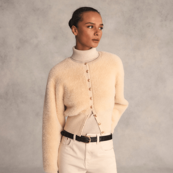A model wearing the J.Crew Fitted Waist Cardigan Sweater in sand colorway