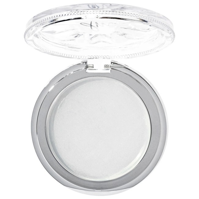 Danessa Myricks Beauty 
Dew Wet Hydrating and Highlighting Balm in a clear compact.
