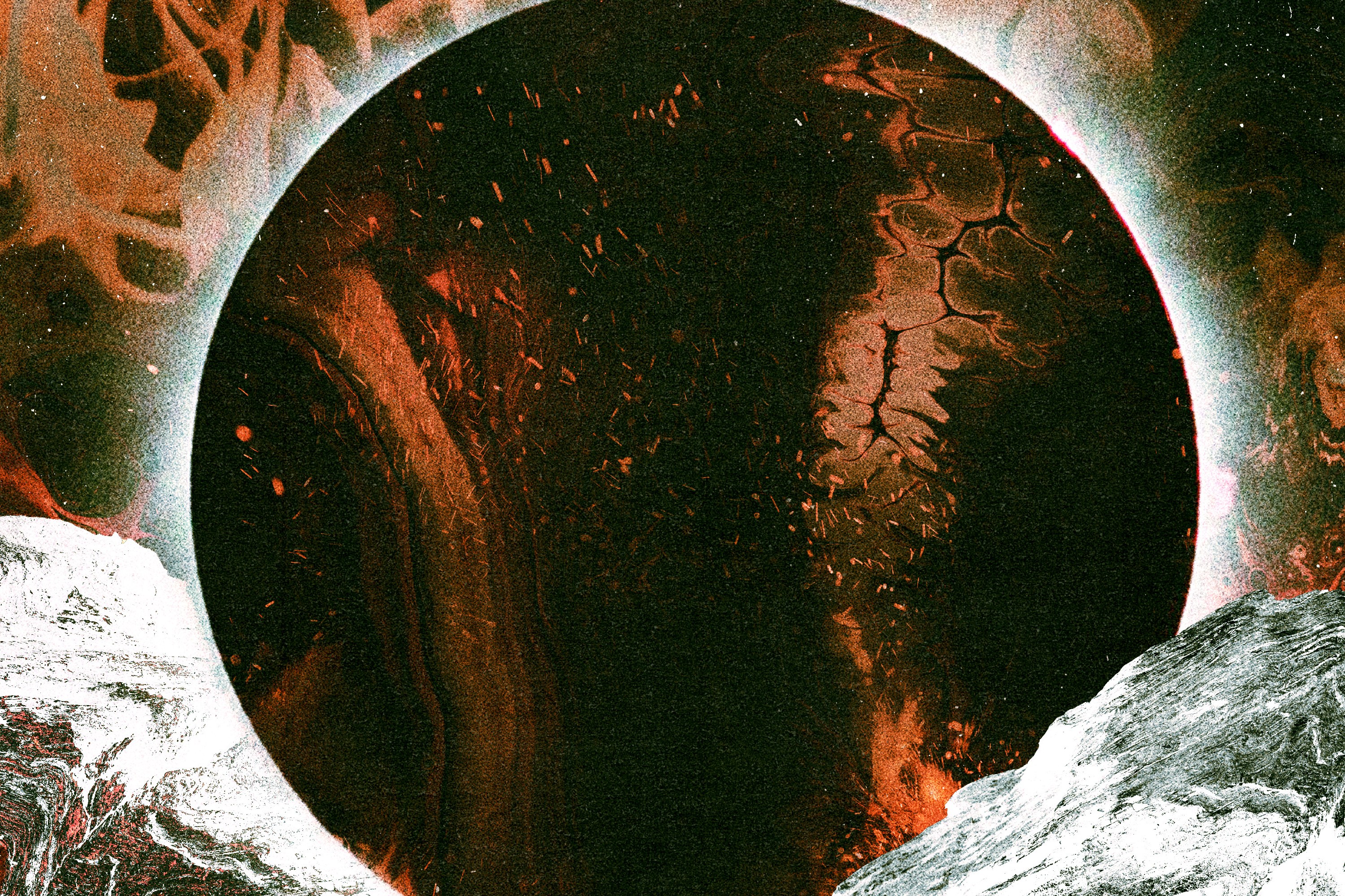 A solar eclipse over a black and orange backdrop