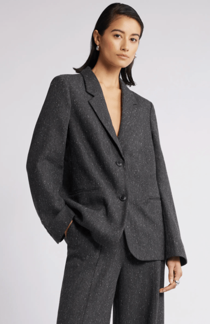 A model wearing the Nordstrom Textured Boyfriend Blazer in a dark grey colorway