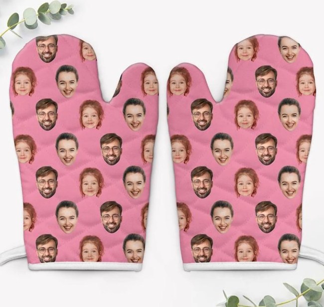 A pair of pink oven mitts with a family member's faces on them