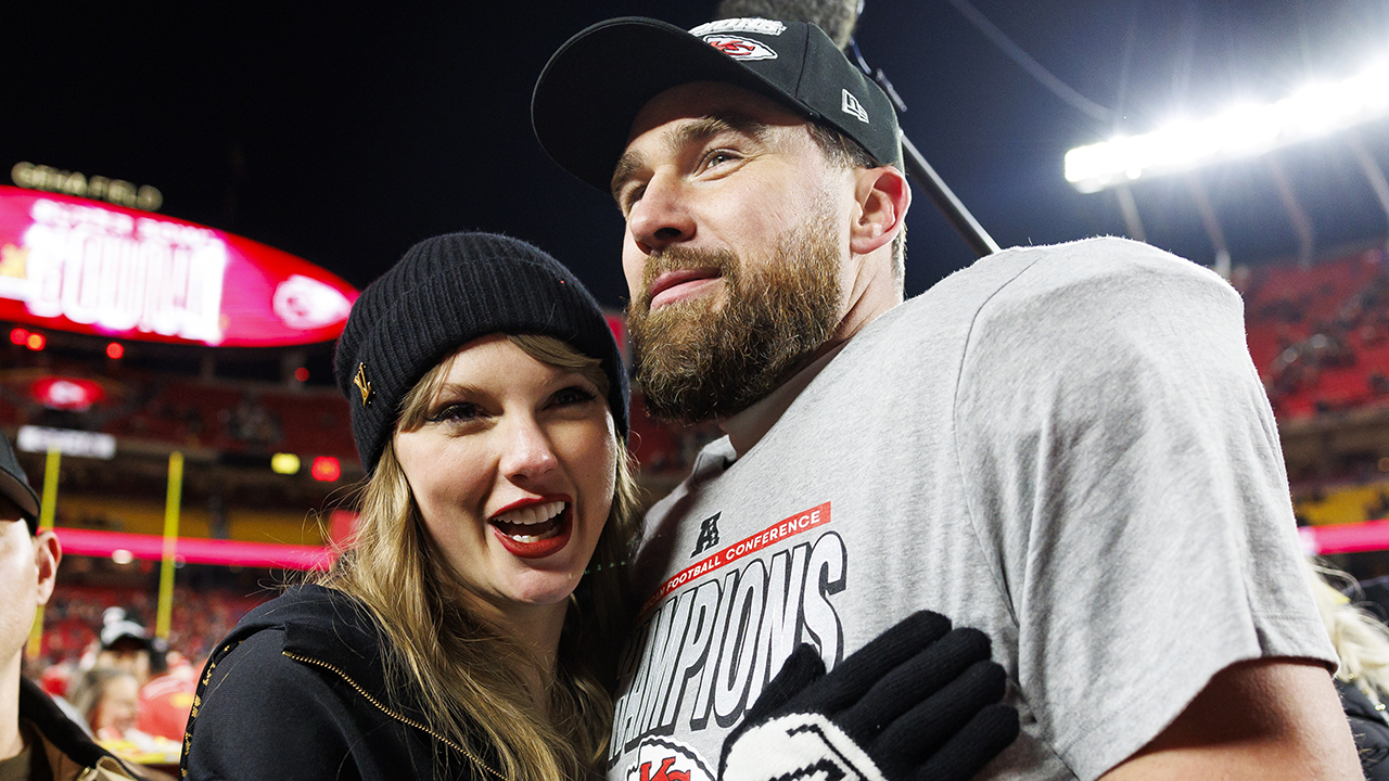 KANSAS CITY, MISSOURI - JANUARY 26: Tight end Travis Kelce #87 of the Kansas City Chiefs celebrates with Taylor Swift after the AFC Championship football game against the Buffalo Bills, at GEHA Field at Arrowhead Stadium on January 26, 2025 in Kansas City, Missouri.