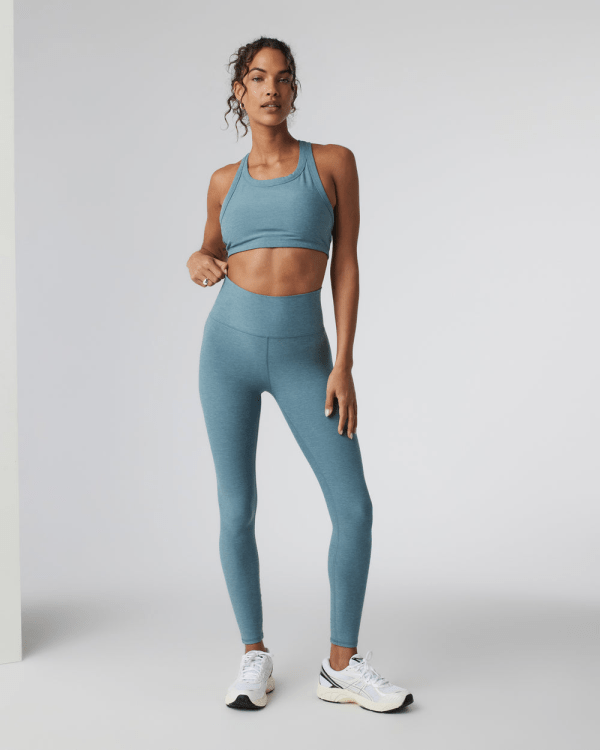 A model wearing the Vuori Clean Elevation Legging in smoke blue heather