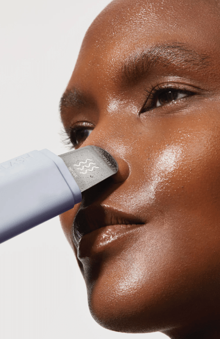 A woman useing the Dermaflash DERMAPORE+ Ultrasonic Pore Extractor + Skin Care Infuser on her nose