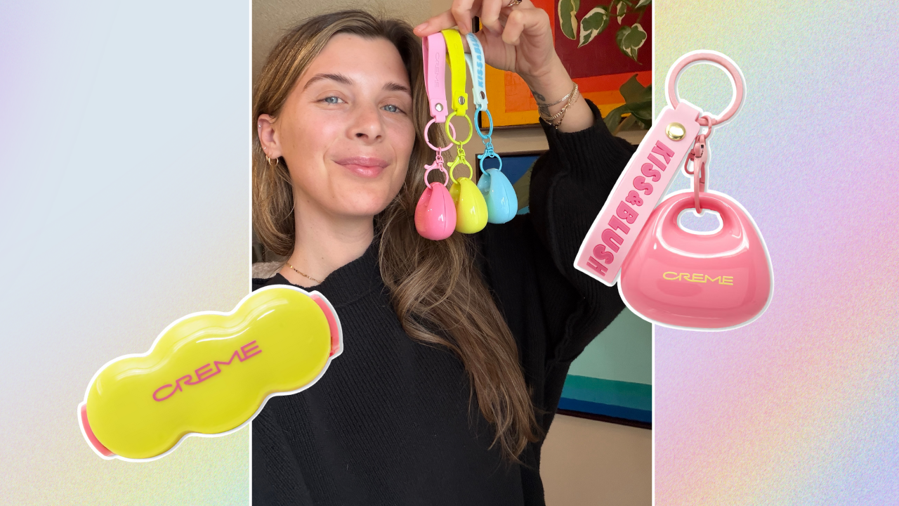 Woman holding up three purse-shaped plastic bag charms in pink, yellow, and blue; a pink plastic purse-shaped bag charm, a yellow scalloped lip balm compact.